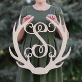 An image of a woman holding the Antler Wooden Monogram Sign from 48 Hour Monogram.
