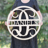 woman holding wooden name sign in a circle