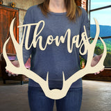 Woman holding wooden antler name sign