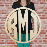 An image of a woman holding the modern style wooden monogram sign from 48 Hour Monogram.