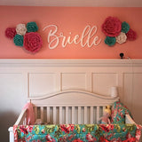 white wooden monogram sign above crib